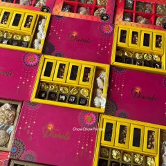 An overhead view of some of the different Diwali hampers I offered. You can see the variety in box colours and the assortment of sweets inside each one.