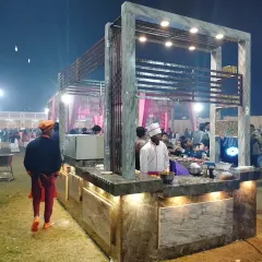 A chef at the live station, focused on preparing a dish. This highlights the fresh, on-the-spot cooking that makes my catering service special.