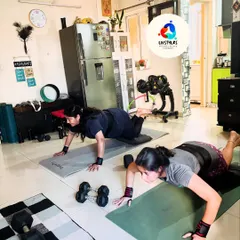 Two clients perform modified push-ups, building upper body strength. I tailor exercises to each individual's level, ensuring a safe and effective workout.