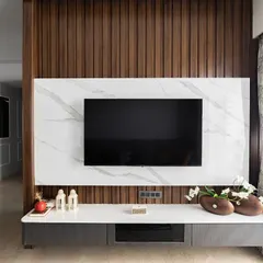 This view highlights the beautiful contrast between the natural wood paneling and the bright, airy feel of the room, enhanced by the large window and sheer curtains.