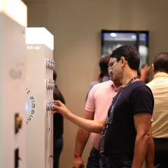 An attendee explores a display of smart dimming switches, getting a practical feel for the user experience and design of modern lighting controls.