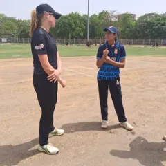 Cricket is a universal language. Here, one of our players shares a moment with a player from the New Zealand Caps team, discussing the game. These interactions are a valuable part of the international match experience we offer.