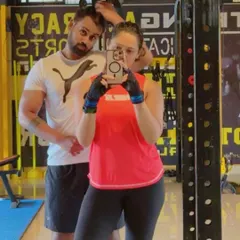 A quick gym selfie capturing a moment from Sachin and Harshitha's partner training session. Working out together provides built-in accountability and makes the fitness journey more enjoyable.