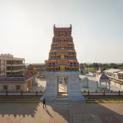 The main Gopuram stands as a monumental entrance to the spiritual heart of the complex. The scale is designed to evoke a sense of awe and reverence, marking the beginning of the 'adhyatmika gola' or spiritual realm for visitors.