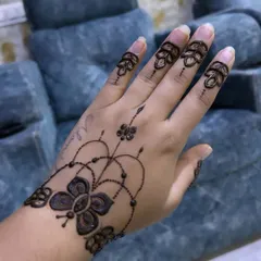 Simple, elegant, and beautiful. This design features a butterfly motif on the wrist with delicate beaded chains connecting to floral patterns on the fingers.