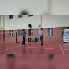 We offer both group and personal coaching to suit every player's needs. This photo from a one-on-one badminton session highlights the focused attention we provide to help players refine their technique.