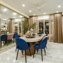 A different angle of the dining space from image 180, focusing on the elegant marble-top table and the interplay of pink and blue velvet chairs.