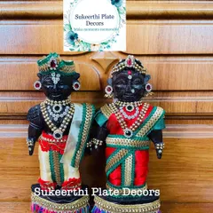 A beautifully decorated Marapachi couple, sent to a client in Thrissur for her baby shower. The dolls are adorned with rich fabrics and stone-work jewellery.