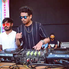 In the zone during the Bengaluru Holi Utsav. I'm focused on the mix, blending hard trance and Bollywood tracks on my Pioneer DJ gear to keep the festival energy at its peak.