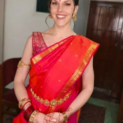 A beautiful fusion look, blending traditional Indian elements with a modern aesthetic. The client wears a stunning Kanjivaram saree, styled with natural, glowing makeup and a simple maang tikka for a fresh take on bridal beauty.