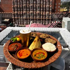 Food photography is not just about the dish, it's about the story. Here, a traditional Rajasthani thali is captured at The Tattoo Cafe, with the iconic Hawa Mahal creating a stunning, unforgettable backdrop that connects the food to its culture.