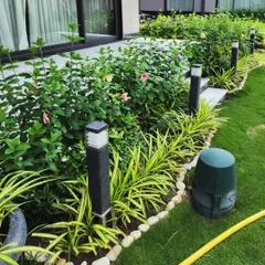 A close-up of the flowering hedge and pathway lighting at our G-Town Wines project. We pay close attention to details like stone borders and integrated lighting to complete the premium look.