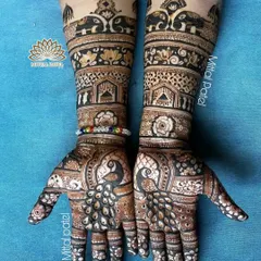 Perfect for the mother of the bride, this design features majestic peacocks on the palms and elephants on the arms, surrounded by floral patterns.