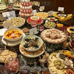 Every element is thoughtfully placed to create a visually stunning landscape of food. This setup includes our popular black olive tapenade and sun-dried tomato dip.