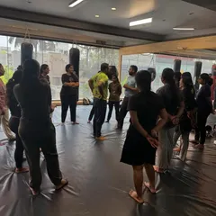 A coach addresses the group at the start of a session. We always begin by explaining the principles of situational awareness and the mindset required for effective self-defence, creating a foundation of knowledge before the physical training begins.