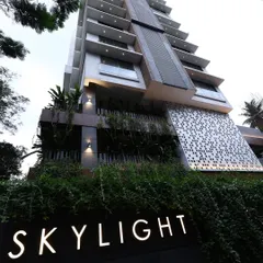 The Skylight building at dusk, where architectural form meets carefully orchestrated light. The illuminated signage and articulated facade details create a strong identity, showcasing how contemporary design can make a powerful statement in the urban environment.