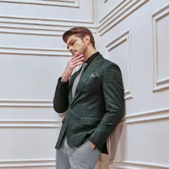 A thoughtful moment in the green checked suit. The unique color palette and classic pattern make it a sophisticated choice for making a statement in a professional setting.