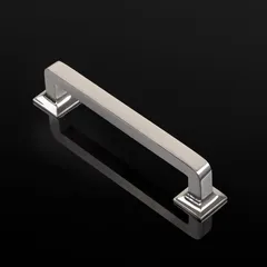 A clean, catalog-style shot of a silver cabinet handle against a reflective black background. This type of photography emphasizes the product's form, finish, and precise design, ideal for hardware brands and e-commerce platforms.