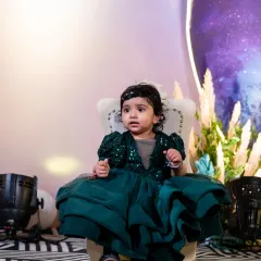 The birthday girl seated on her little throne. A cute portrait capturing her in a moment of curiosity.