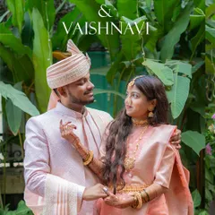 An elegant portrait of the couple, Dhanmendra and Vaishnavi, on their Haldi day, dressed in beautiful coordinated pastel pink outfits.
