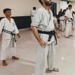 A good stance and posture reflect a proper state of mind. Here, students of different ages practice maintaining their form and focus during a class.