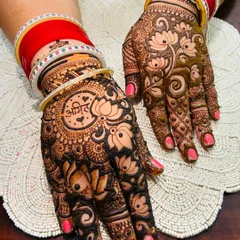 A beautiful design featuring the groom's name, "Anil," inside a lotus mandala. This is a classic and romantic way to include your partner in your mehndi.