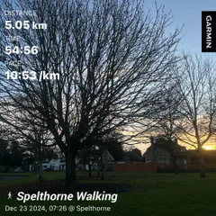 A Garmin data screen showing a 5km morning walk in Spelthorne, UK. Active recovery and easy movement are just as important as intense training.