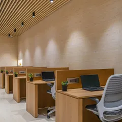 Functionality is key in a workstation. Each desk is equipped for productivity with ergonomic chairs and a touch of greenery from small planters to enhance the calming, natural ambiance of the space.