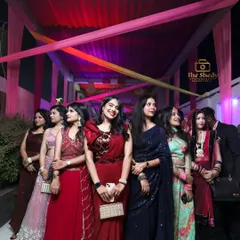 The bride's squad! A beautiful group photo of the bridesmaids and friends, all dressed up for the wedding festivities.