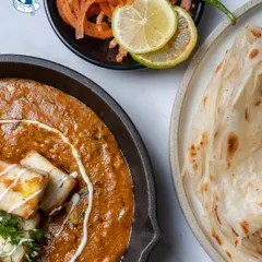 The classic combination of Paneer Makhani and Laccha Paratha. Our version features soft paneer in a rich, creamy tomato gravy, a must-have for any Indian wedding menu.
