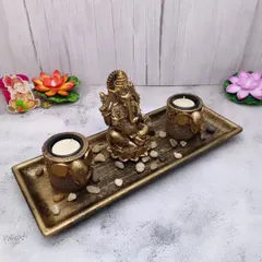 A serene Ganesha candle stand decor set, with a Ganesha idol and two candle holders on a tray. A complete decor gift in one box.