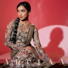 A stunning studio shot of the olive green draped saree gown. The intricate silver floral embroidery on the sheer fabric creates a beautiful illusion effect.