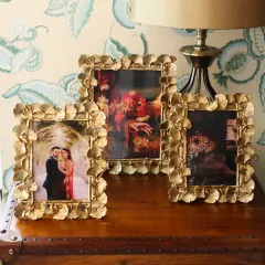 Our stunning ginkgo leaf frames, available in multiple sizes. The intricate, overlapping leaf design in a vintage gold finish makes these frames a true statement piece for any side table or mantel.