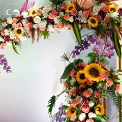 A magnificent floral arch created for the Haldi ceremony, bursting with sunflowers, roses, and orchids. This vibrant explosion of color made for a stunning photo backdrop.