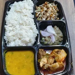 This is our Chicken Manipuri Thali, packed for delivery. It features Manipuri-style chicken curry, dal, iromba (a fermented fish and vegetable mash), a fresh salad called singju, and steamed rice.