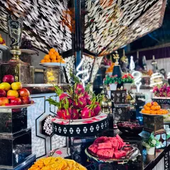 A symphony of colors and textures, this fruit display includes sliced oranges, watermelon, and whole dragon fruit.