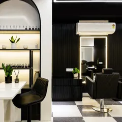 In a salon, elegance must meet function. This manicure station features a striking arch backdrop to display nail colors, creating a playful yet sophisticated focal point. The design balances symmetry and clean lines for a calm, captivating oasis.