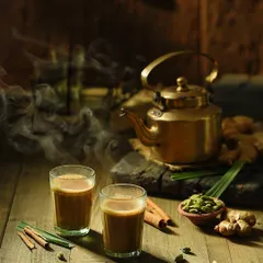 A slightly different composition from the chai series, this shot focuses on the ingredients like ginger, cardamom, and cinnamon sticks. This type of detailed food styling is great for recipe books or brand packaging.