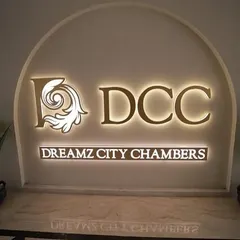 The finished lobby of Dreamz City Chambers, where elegant design welcomes visitors. The illuminated signage and clean material palette create a professional and sophisticated entry point for this commercial building.