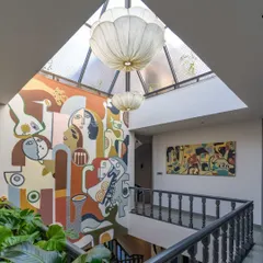 Looking down from the upper level, you can see how the mural connects the different spaces of the home. The composition is designed to be appreciated from multiple viewpoints, revealing new details from every angle.