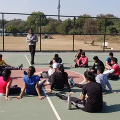 Coaching goes beyond physical drills. In this photo, I am talking with our players during a break, discussing strategy and the mental aspects of the game to build their basketball IQ.