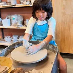 This young potter is completely absorbed in her work at the wheel. Our summer camps provide a supportive environment for kids to explore their creativity.