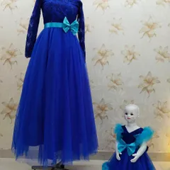 This royal blue mother-daughter set combines a lace bodice with a full tulle skirt. The bright turquoise bow adds a fun pop of color to both the mother's gown and the daughter's frock.