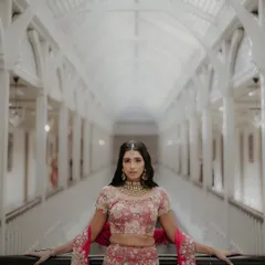 A stylish portrait of Nandini and Sahil at the Taj Mahal Palace, Mumbai. The grand, symmetrical hallway provides a stunning architectural backdrop for this elegant and poised couple shot.