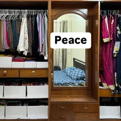 This is the peace that follows. After sorting, decluttering, and creating a system with designated zones and storage bins, the same wardrobe is now a source of calm and efficiency.