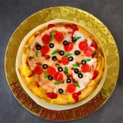 Is it a pizza or is it a cake? This is my popular illusion cake, designed to look exactly like a pepperoni and olive pizza. Underneath the realistic fondant toppings and airbrushed crust is a decadent Nutella chocolate chip cake, offering a fun and delicious surprise.