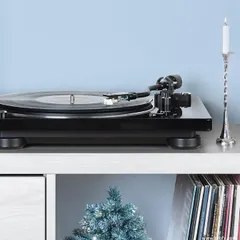 A Denon turntable setup, elegantly placed for the holiday season. We believe in creating audio experiences that become part of your home's ambiance, and a classic vinyl setup offers both superior sound and timeless style.