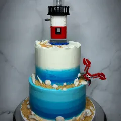When a bride wants something totally unique, we are all in. This two-tiered beach-themed wedding cake, complete with a real Lego lighthouse and lobster, was so much fun to create for a couple with a great sense of humor.