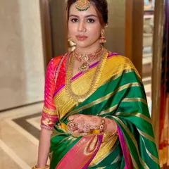 A detailed close-up of the makeup, showing the defined eyes and flawless skin that complement the traditional attire.