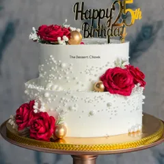 An elegant two-tier cake for a 25th birthday, made with my popular eggless Rasmalai cake flavour and decorated with beautiful red roses.